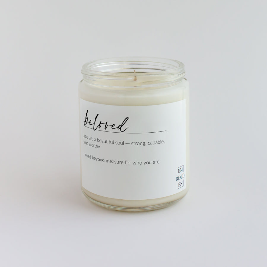 'Beloved' scented candle in a clear jar, designed to evoke feelings of love and warmth.