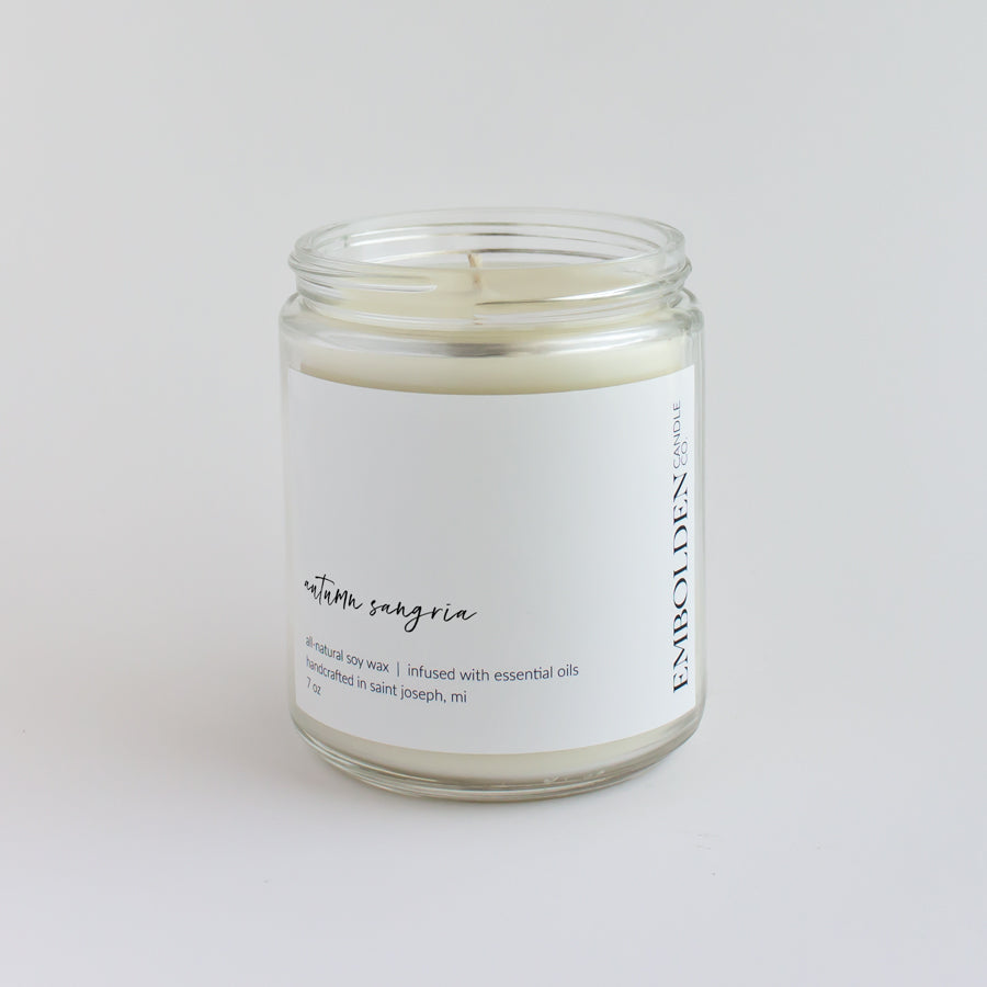 'Autumn Sangria' scented candle in a clear jar, evoking the essence of cozy autumn evenings.
