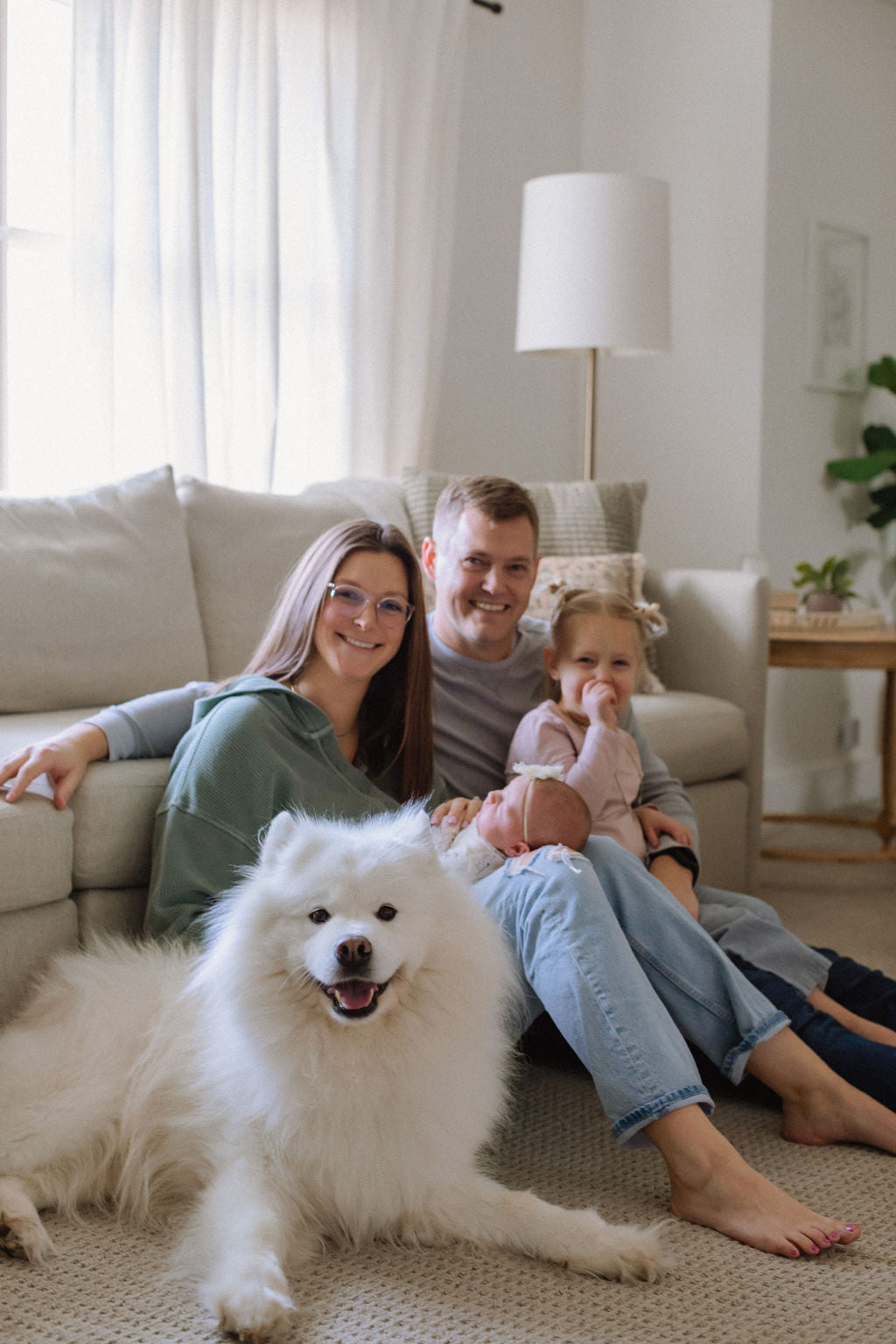 Leah and Mike, founders of Embolden Candle Co, with their two daughters and dog, Mowgli